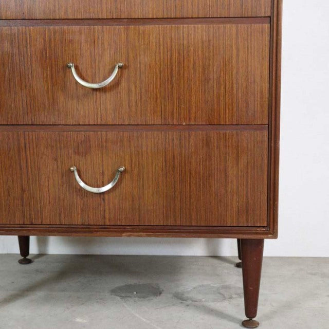 Mid-century British vintage teak chest with six drawers, visible wood grain, and tapered round legs from Denmark style.