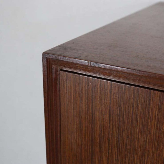 Mid-century teak vintage British chest corner showcasing rich wood grain and smooth finish.