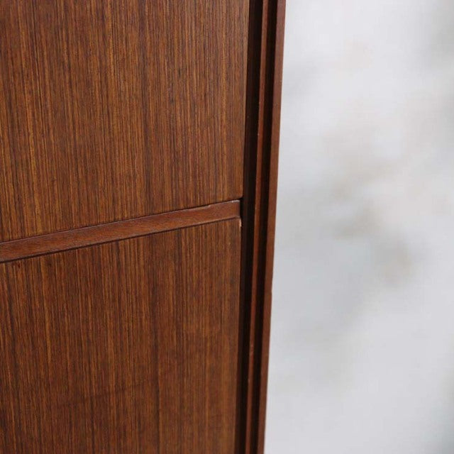 Close-up of vintage teak mid-century British chest drawers showing smooth wood grain and refined craftsmanship.