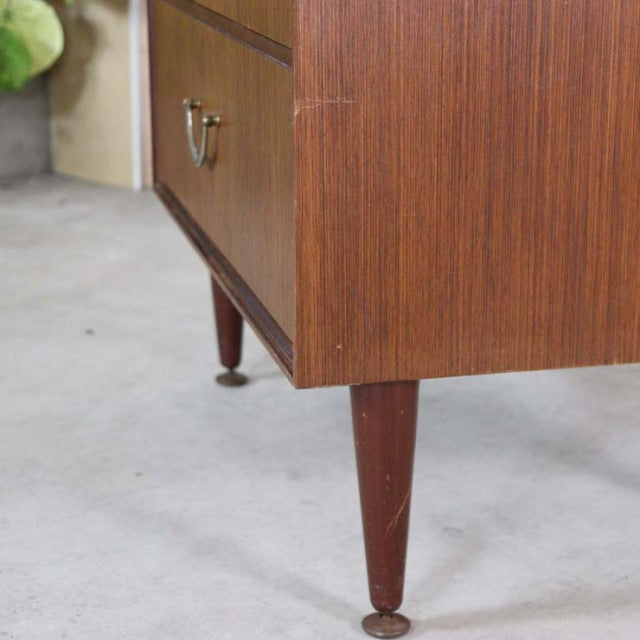 Vintage mid-century teak chest with tapered British legs and rich wood grain detailing.