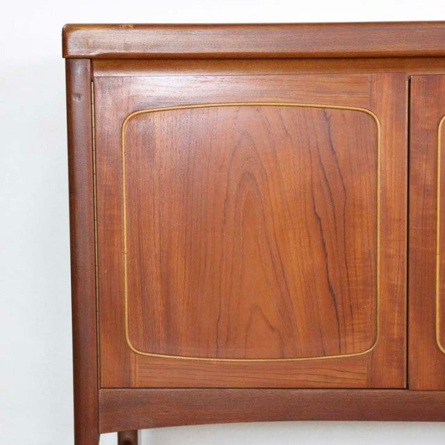 Vintage British mid-century teak sideboard by Nathan with rounded square panel and warm wood grain.