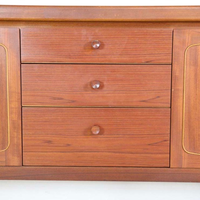 Vintage teak mid-century British sideboard by Nathan featuring rich wood grain, rounded wooden knobs, and detailed inlay on.