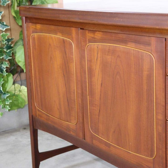 Mid-century British vintage teak sideboard by Nathan with rich wood grain and rounded panel doors.