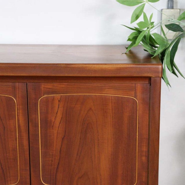 Mid-century British teak sideboard by Nathan with rich wood grain, rounded corners, and tapered legs.