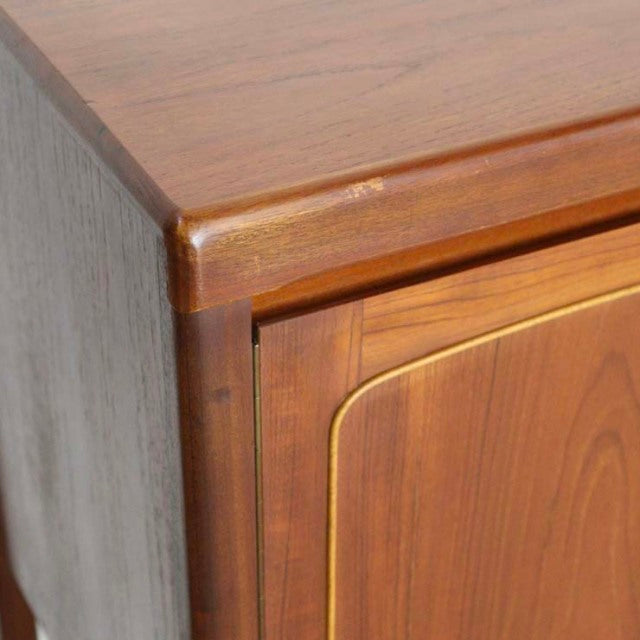 Vintage British mid-century teak sideboard corner showing smooth wood grain and rounded edge detailing.
