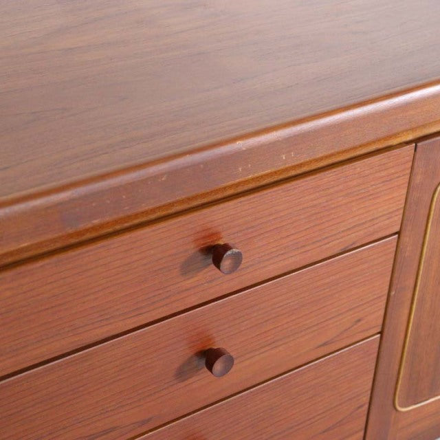 Mid-century British vintage teak sideboard by Nathan with rich wood grain and round wooden drawer knobs.