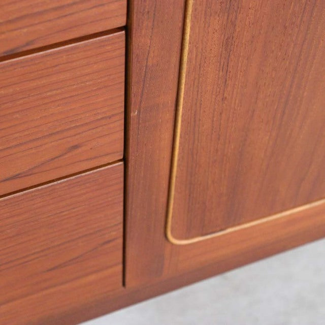 Close-up of vintage mid-century British teak sideboard by Nathan with rich wood grain and inset panel detailing.