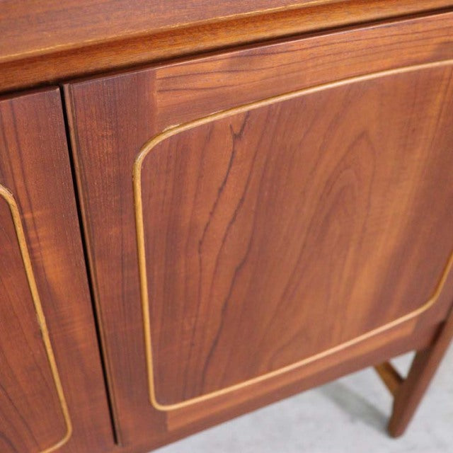 Vintage British mid-century teak sideboard door with rounded-edge panel and visible wood grain.