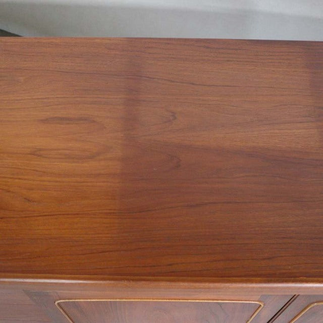 Mid-century British vintage teak sideboard by Nathan with rich wood grain and smooth square top surface.