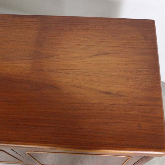 British mid-century NATHAN vintage teak sideboard with smooth wood grain and rounded edges.