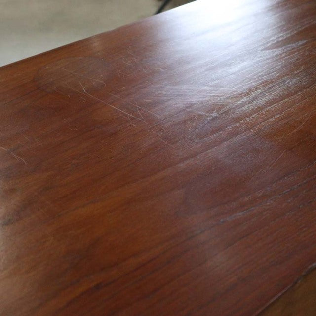 Vintage teak wooden surface with rich grain, reflecting mid-century British craftsmanship by Nathan.