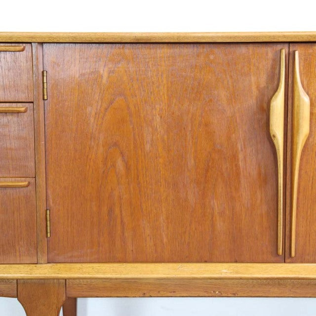 Mid-century British vintage teak sideboard door with rich wood grain and sculpted vertical handle detailing.