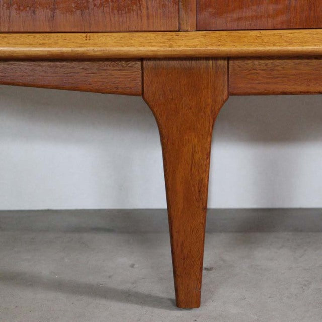 Mid-century British vintage teak sideboard leg with warm wood grain and tapered design from Jentique.