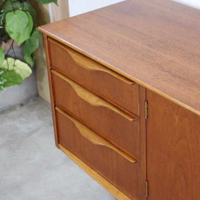 Mid-century British vintage teak sideboard by Jentique with curved drawer pulls and rich wood grain.