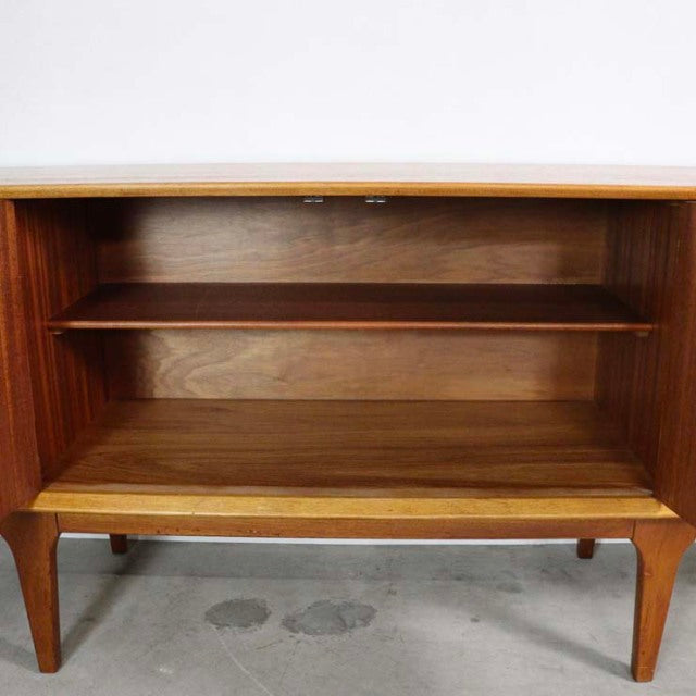 Mid-century British vintage teak sideboard by Jentique with rich wood grain, tapered legs, and open shelving.