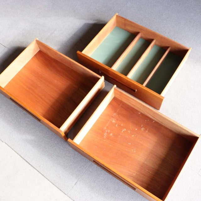 Mid-century vintage teak sideboard drawers with smooth wood grain and green felt-lined compartments, British-Denmark design.