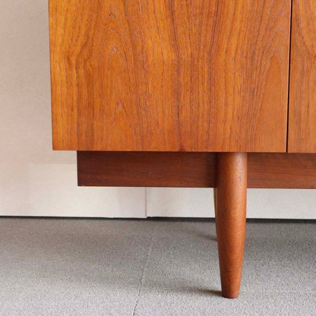 Mid-century vintage British teak sideboard leg with rich wood grain and smooth rounded tapered design.