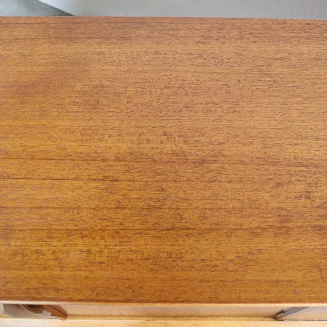 Vintage mid-century teak sideboard top with warm wood grain, British and Danish design influences.