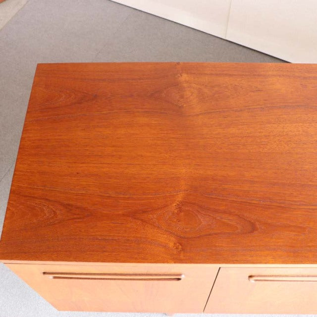 Vintage mid-century teak sideboard with rich wood grain and sleek British-Denmark design.