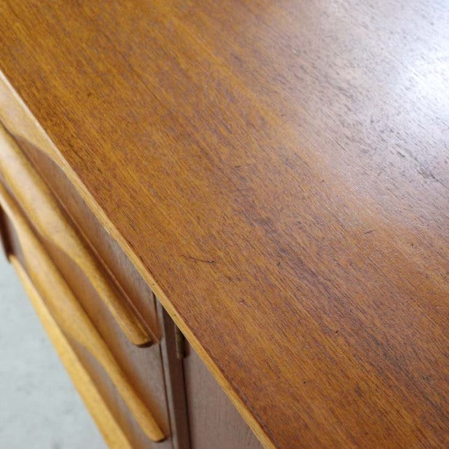 Vintage teak tabletop with rich grain and smooth finish on a British mid-century sideboard by Jentique.