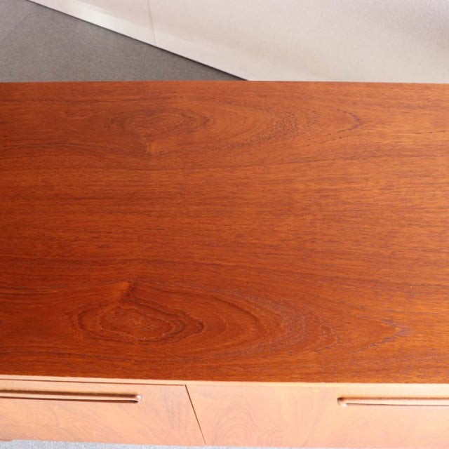 Vintage teak sideboard top showcasing rich wood grain with warm mid-century British and Danish design influences.