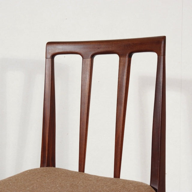 Vintage teak dining chair by Younger with British mid-century design, slender vertical slats and smooth wood grain.
