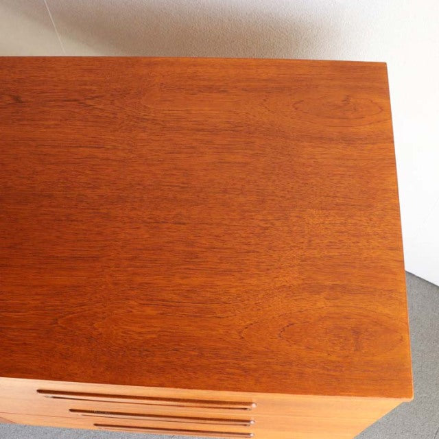 Vintage teak British mid-century sideboard top corner showing rich wood grain and smooth finish.