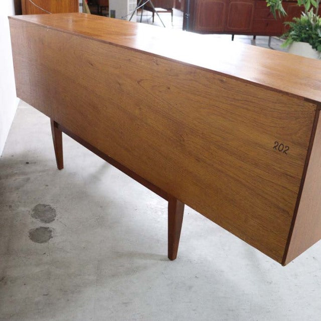 Mid-century British vintage teak sideboard by Jentique with smooth wood grain and tapered legs from Denmark.