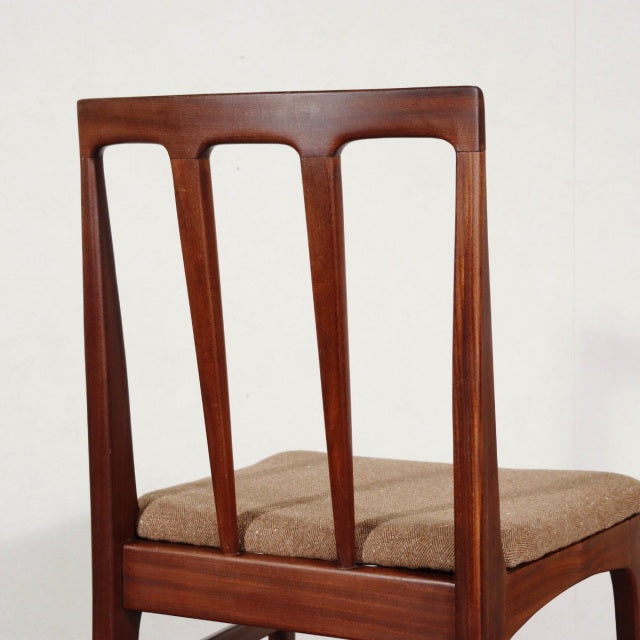Mid-century British vintage dining chair by Younger in teak with tapered vertical slats and beige cushioned seat.