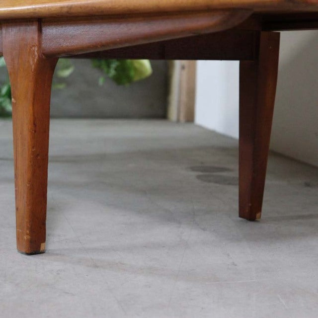 Close-up of teak wood leg on mid-century British vintage Jentique sideboard, showing smooth grain and warm finish.