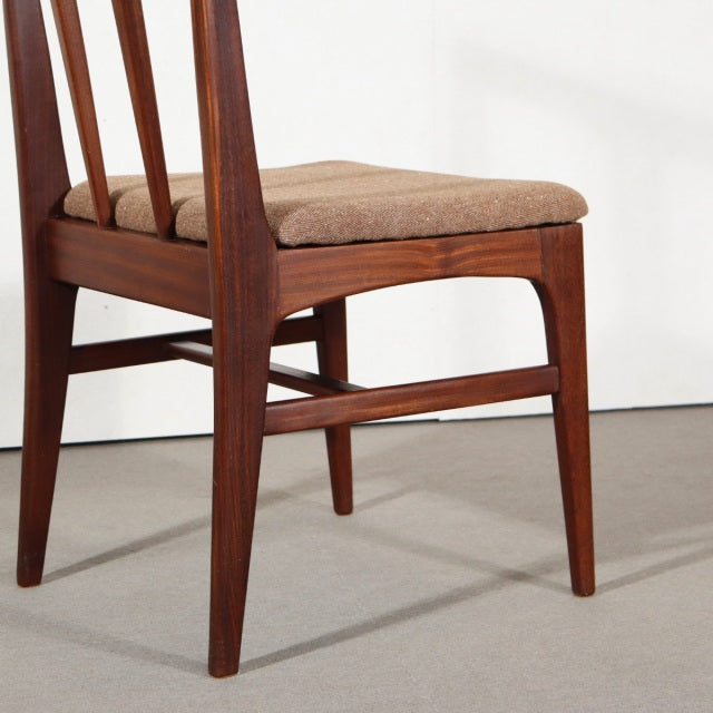 Mid-century British vintage teak dining chair with angled legs, vertical slat back, and beige upholstered seat.