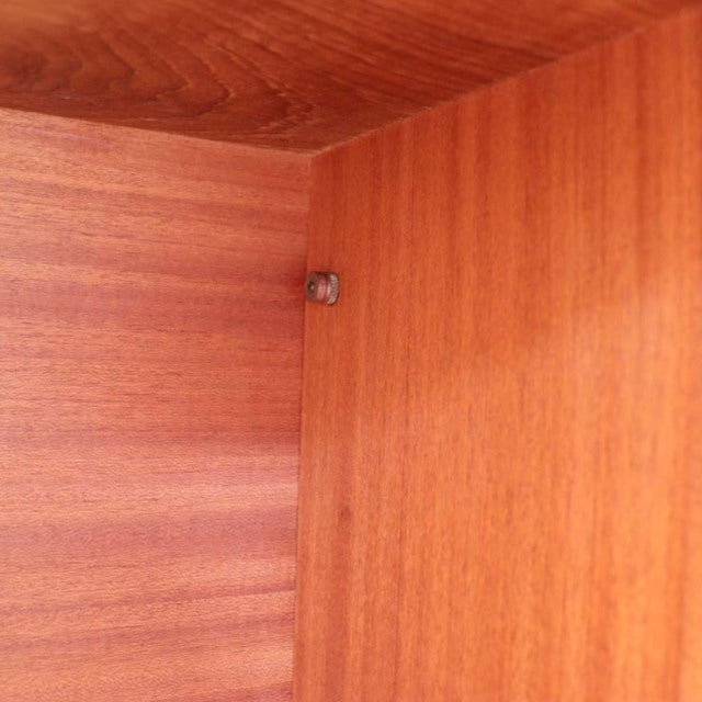 Close-up of vintage teak wood grain and corner joinery on British mid-century Ladderax unit shelf from Denmark.