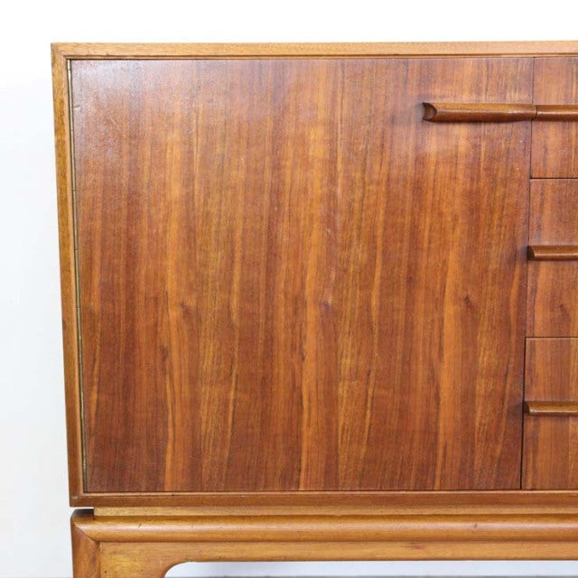 Vintage British mid-century teak sideboard by A.H. McIntosh with rich wood grain, sleek rectangular form, and tapered legs.