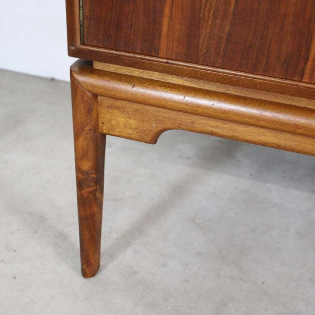 Close-up of British mid-century A.H.McIntosh teak sideboard leg with rich wood grain and rounded detailing.