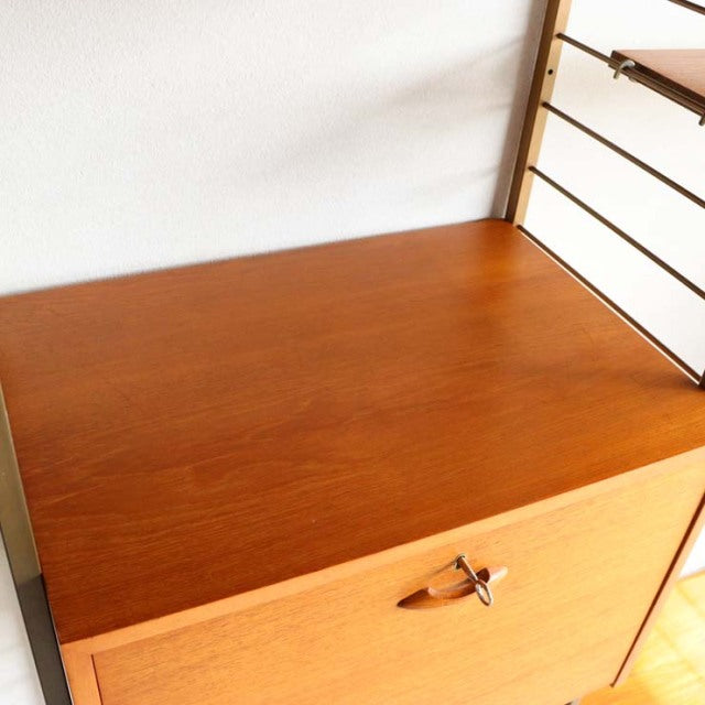 Vintage teak Ladderax shelving unit with mid-century British design, smooth wood grain, and metal ladder frame.