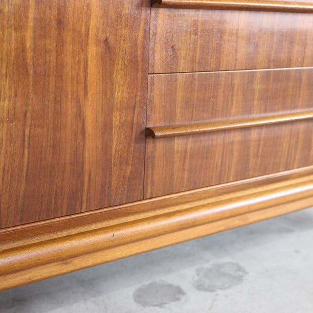 Mid-century British vintage teak sideboard by A.H. McIntosh with rich wood grain and rounded handles.