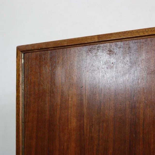 Vintage mid-century teak sideboard corner with rich wood grain and clean British design lines.