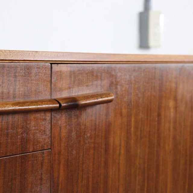 Mid-century British vintage teak sideboard by A.H.McIntosh with rich wood grain and rounded handles.