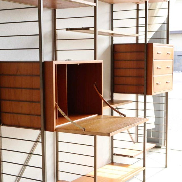 Vintage teak Ladderax shelving unit by Staples, mid-century British design with open cabinet and drawers, sleek wood grain.