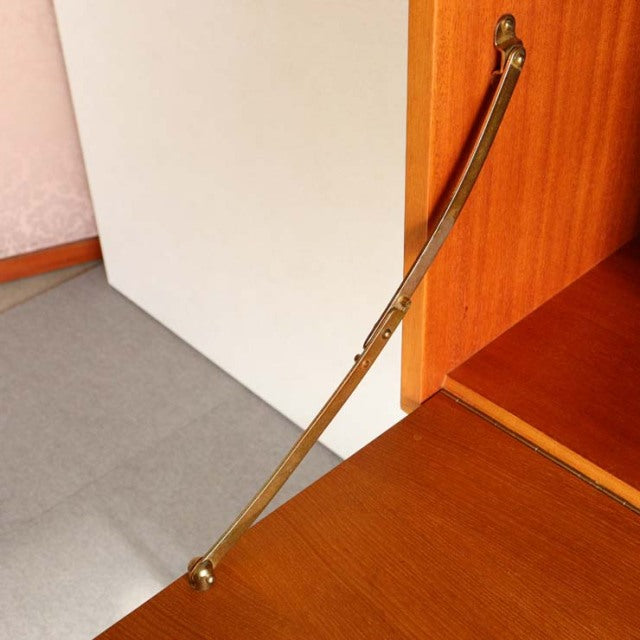 Brass support arm with adjustable hinge on vintage teak Ladderax unit shelf by British Staples, mid-century Denmark design.