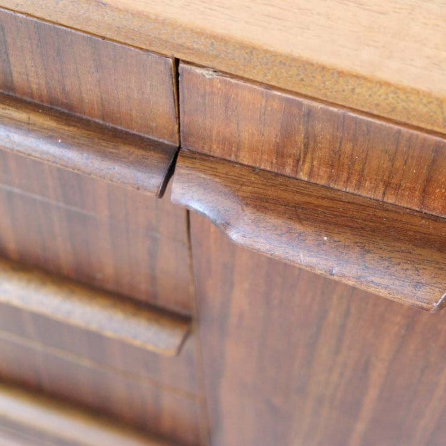 Close-up of British mid-century vintage teak sideboard by A.H.McIntosh, showing rich wood grain and curved drawer handles.