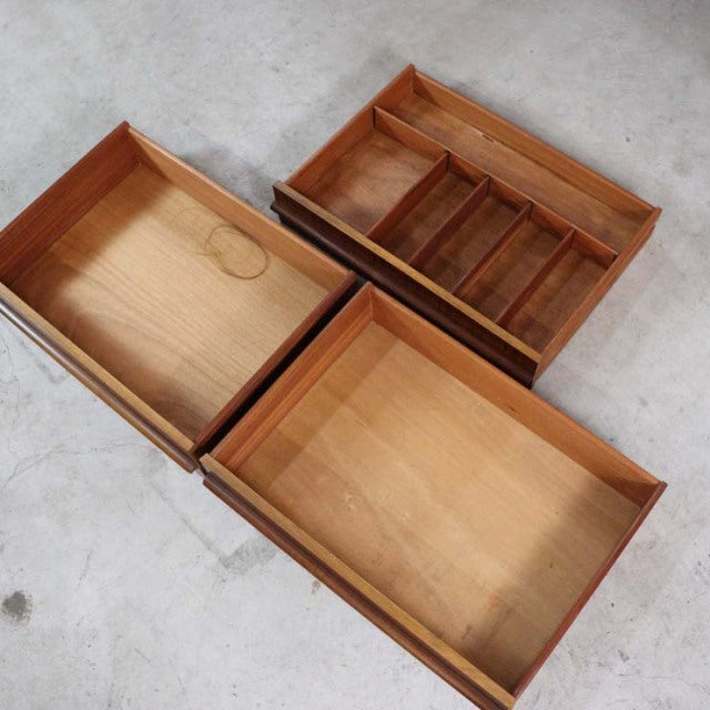 Three vintage teak drawers with visible wood grain and dividers, showcasing mid-century British design from A.H. McIntosh.