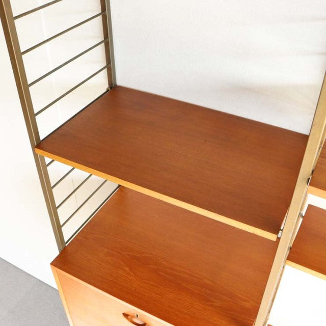 Vintage teak Ladderax shelving unit with British mid-century design, sleek wood grain and metal frame from Denmark.