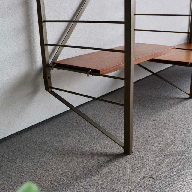 Mid-century British Ladderax shelving unit with teak wood shelves and metal frame legs showcasing fine wood grain and.