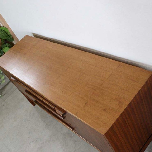 Mid-century British teak sideboard by A.H. McIntosh with rich wood grain and tapered legs.