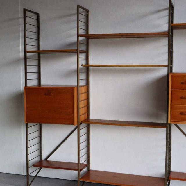Vintage mid-century teak Ladderax shelving unit by British brand Staples, Danish-inspired design with visible wood grain,.