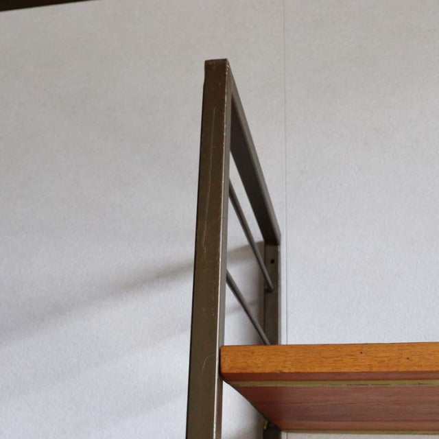 Vintage teak Ladderax unit shelf with dark wood frame, clean mid-century British design, visible wood grain on shelf panel,.