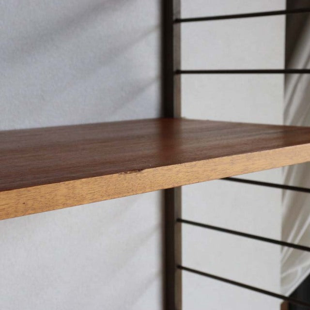 Vintage teak Ladderax shelving unit by British brand Staples, mid-century Danish design, smooth wood grain, slender black.