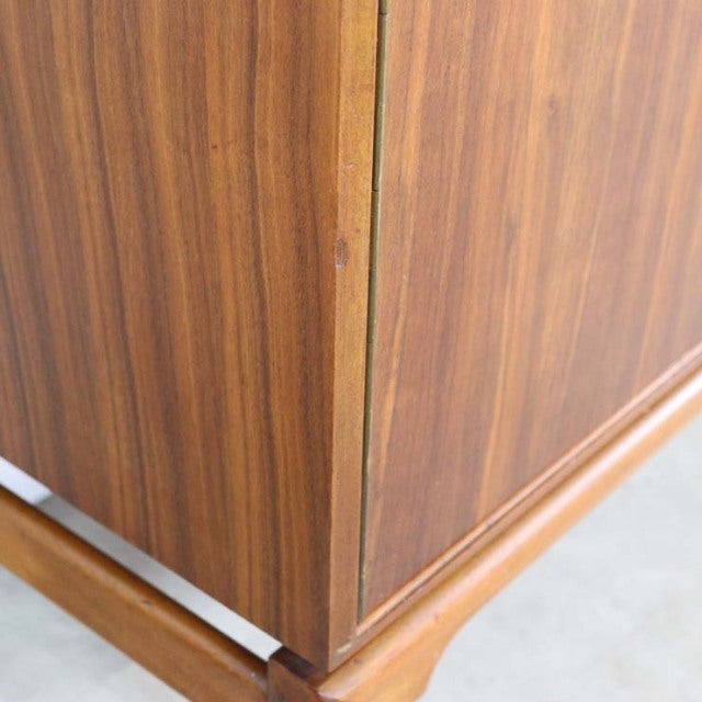Mid-century British vintage teak sideboard corner detail showing wood grain and elegant tapered legs.