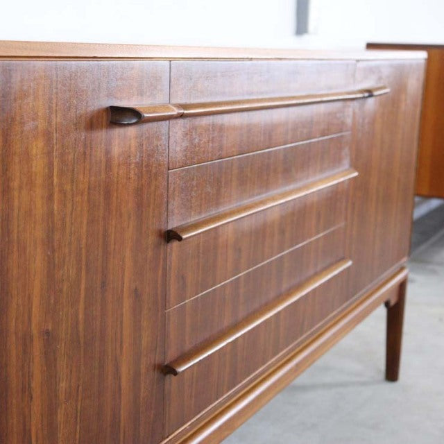 Vintage British mid-century teak sideboard by A.H. McIntosh with distinctive elongated wooden drawer handles and rich wood.